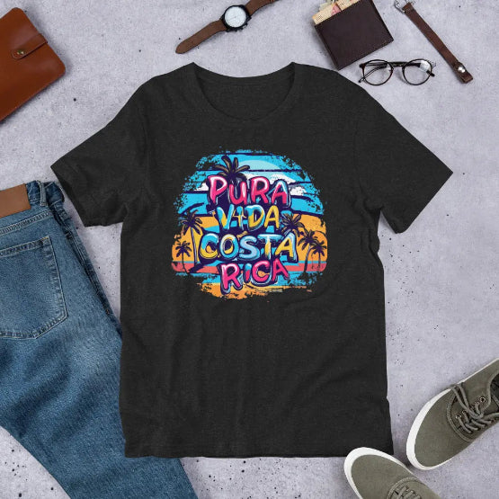 👉 "Unisex t-shirt with a 'Pura Vida CR' design, showcasing Costa Rica’s iconic phrase alongside tropical elements like waves and palm trees."